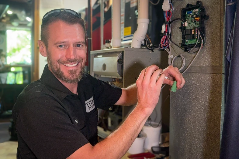 A Titan technician repairing a heating system